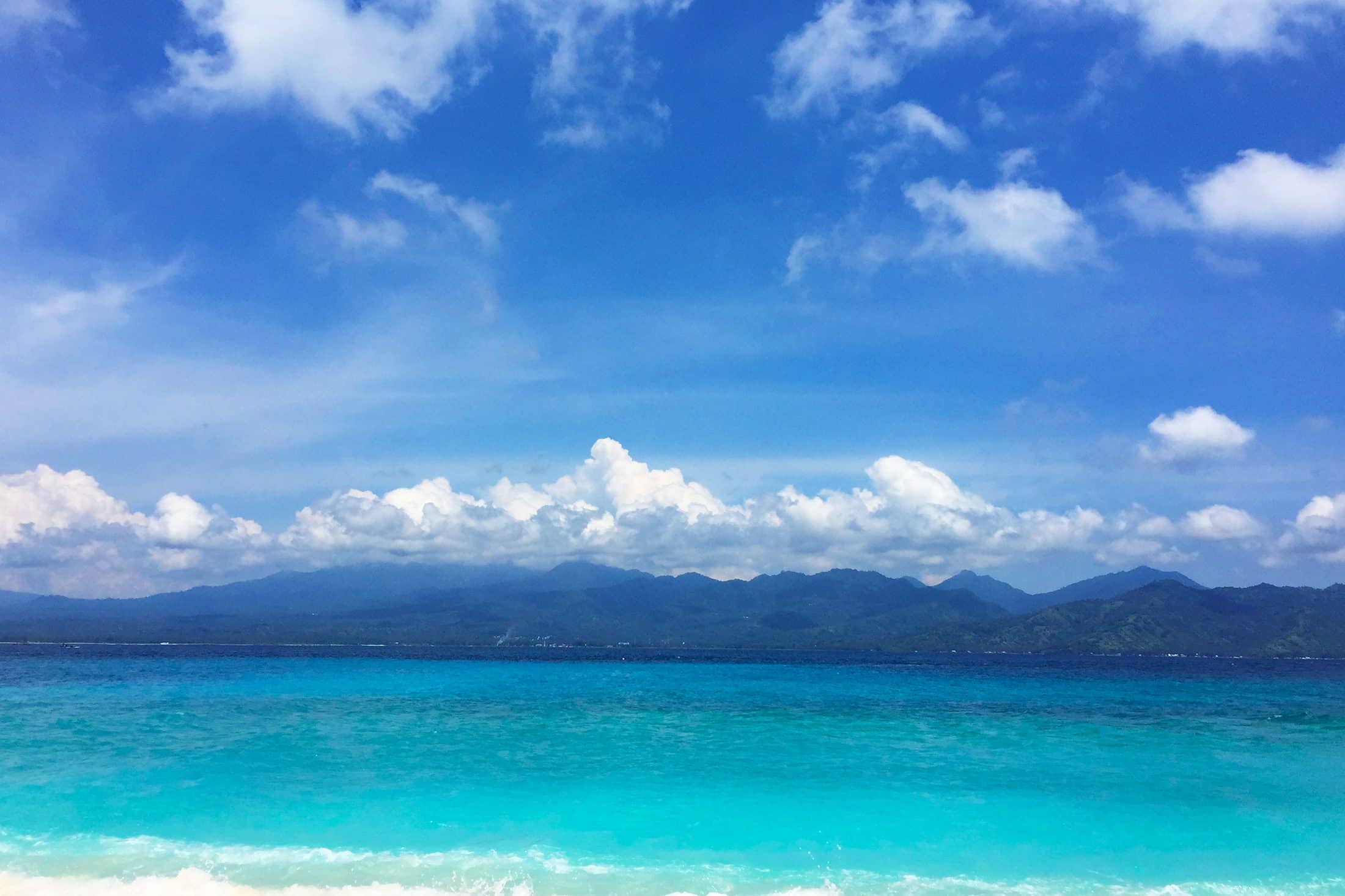 Turquoise water and distant hills on the Indonesian coast