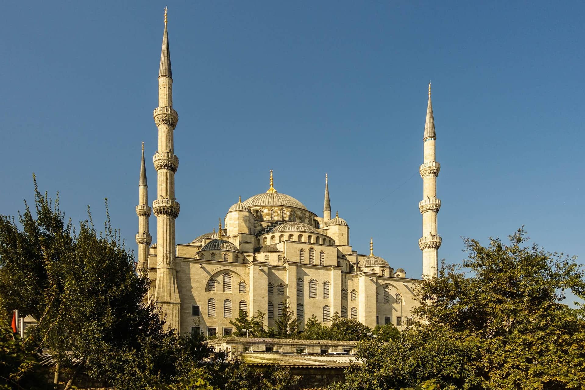 The New Mosque in Istanbul, its domes and slender minarets rising against a bright blue sky